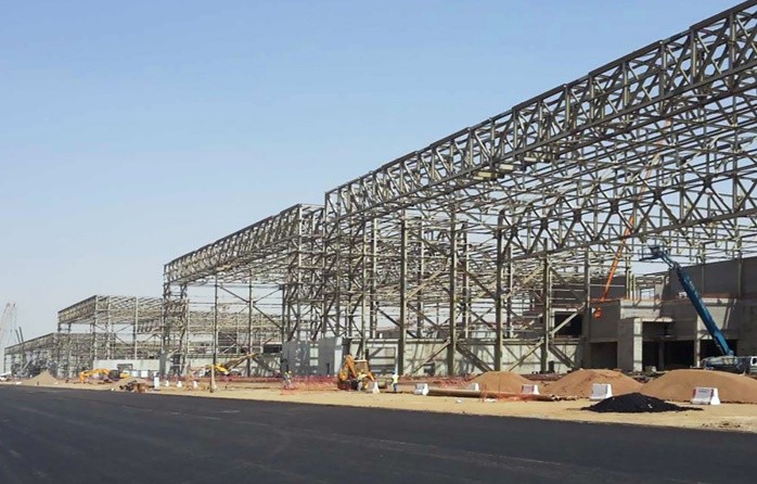 SAZEC GROUP steel structure site with boom lifts and excavators