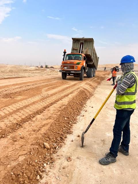 SAZEC GROUP dump truck tipping load with site crew in PPE